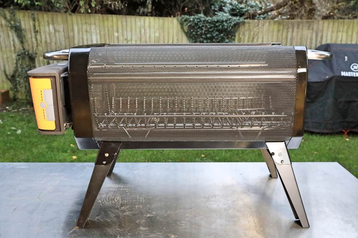 Side view of Biolite Firepit+ on a stainless steel table.