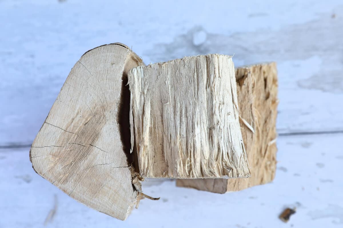 Orange wood chunks on a white wooden table.