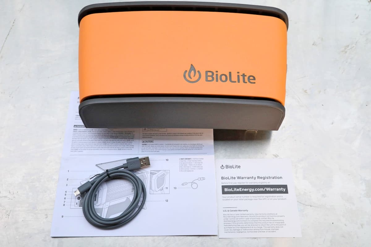 The BioLite Firepit+ power pack box laid out, showing the blower, USB lead, and manual