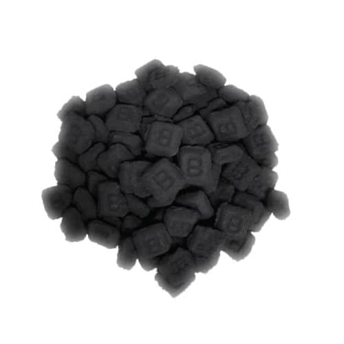 Small pile of B&B charcoal briquettes isolated on white.