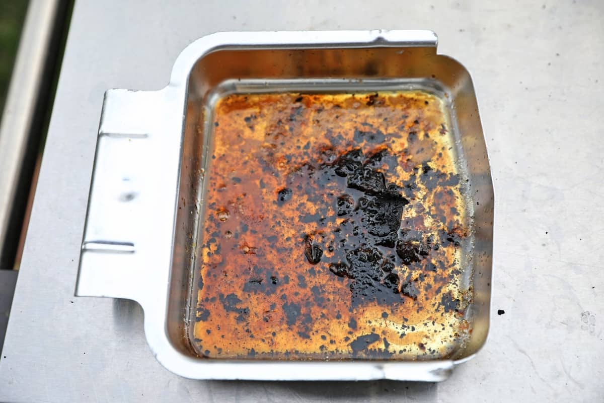 Napoleon TravelQ Pro 285 grease collection pan full of grease and drippings.