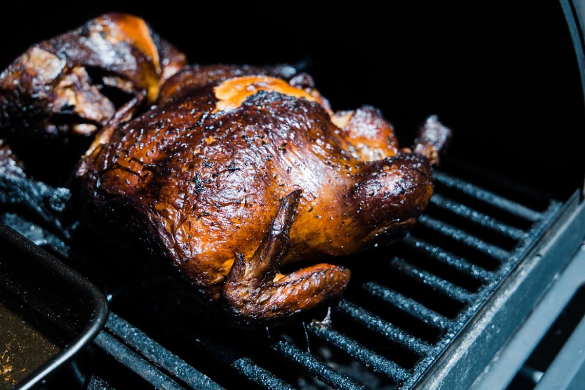smoked chicken on the grill, with dark, shiny skin