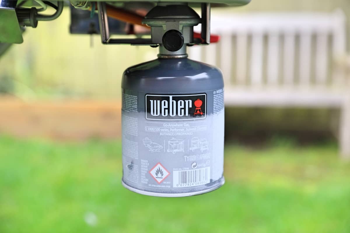 Photo of frozen gas canister under a Weber Traveler gas grill in .