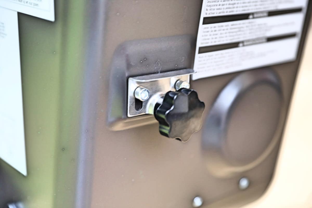 Close up of Camp Chef Woodwind WiFi 36 pellet purge pull knob, on the side of the hopper