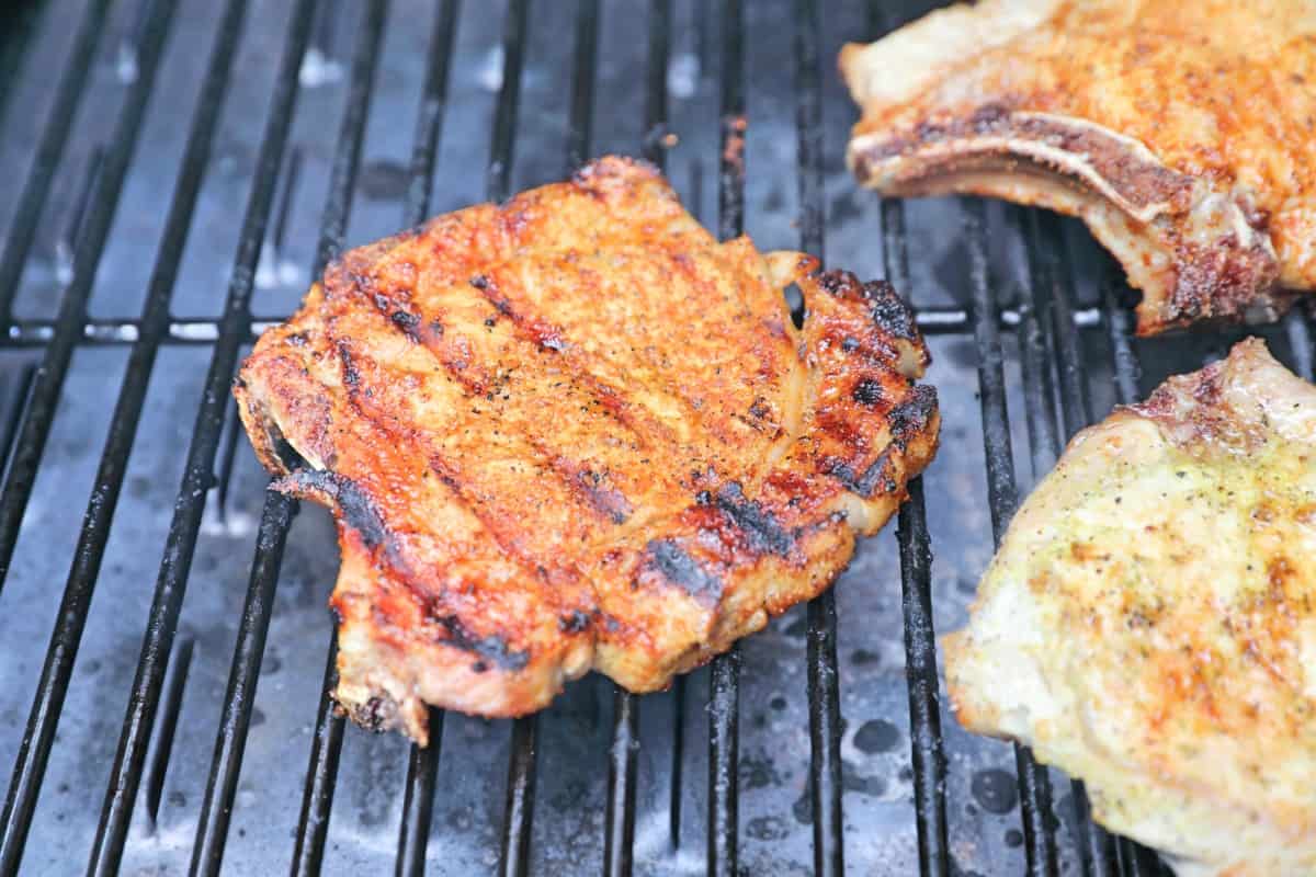 A seared pork chop in a pellet grill