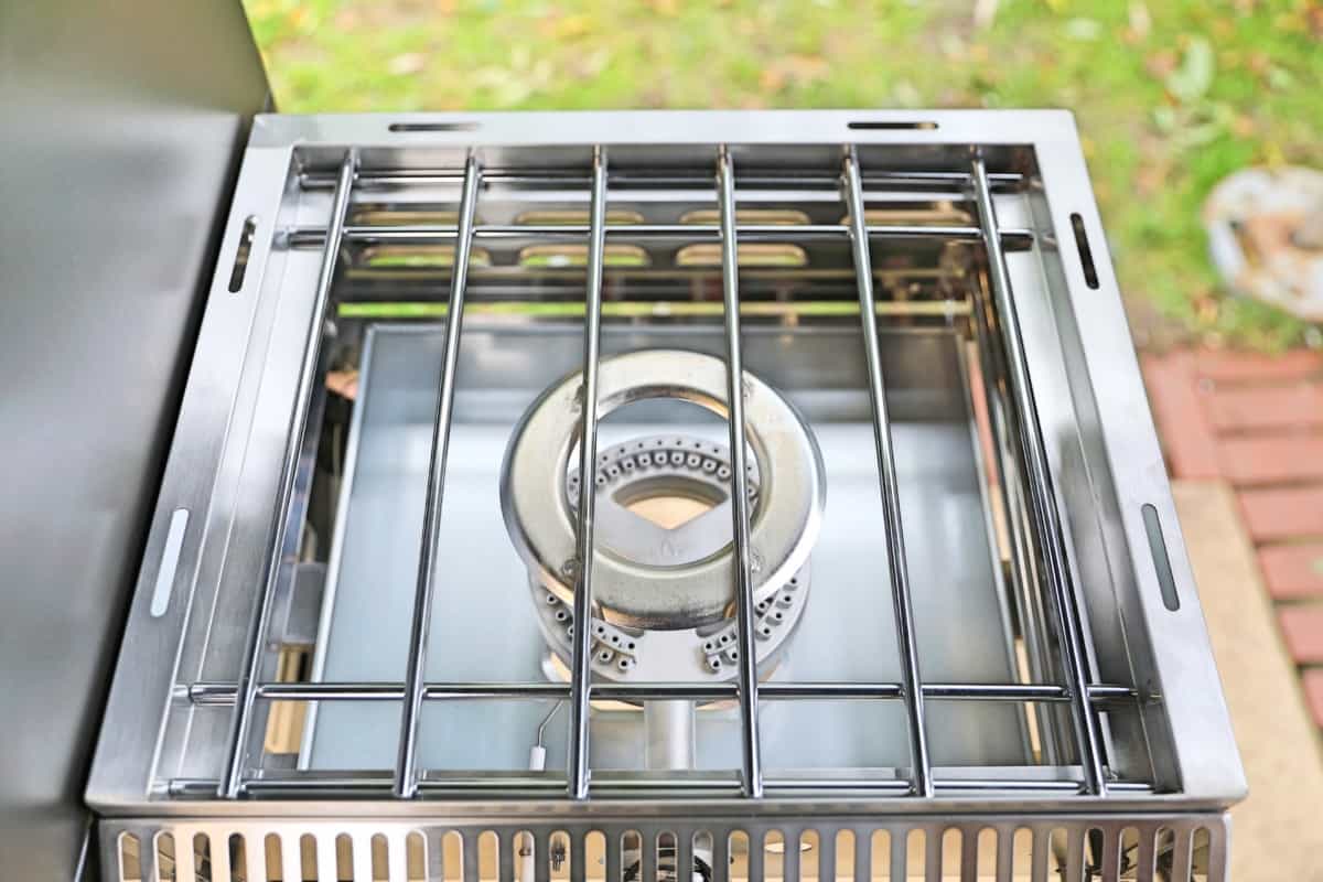The Camp Chef Woodwind Wi-Fi 36 Sidekick attachment shot from above, shoing the burner, and pot holder grate
