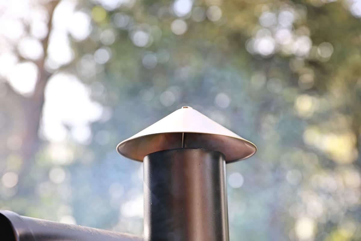 Smoke comiong from a pellet grill chimney