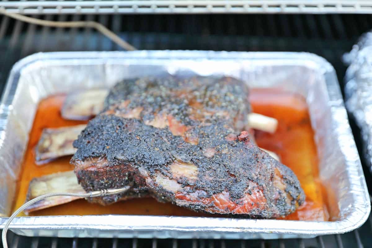 Smoked beef ribs in a foil tray