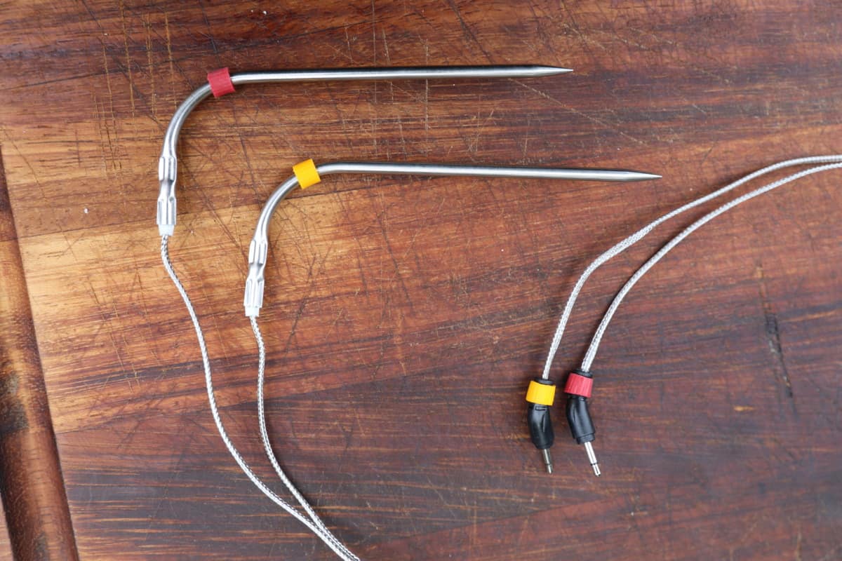 Two Weber iGrill 2 probes, the food probe ends and plug ends, each with either a red or yellow band on to help identify them