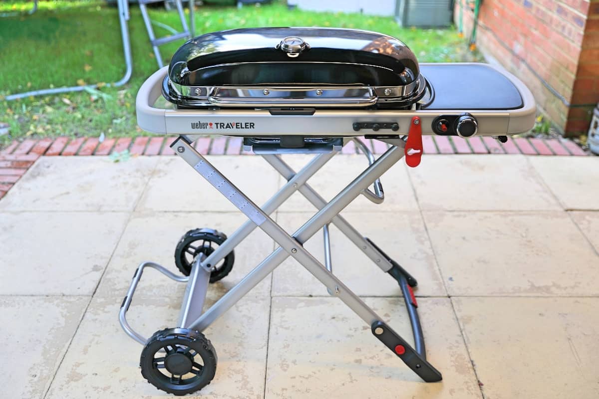 weber traveler portable gas grill standing on a patio
