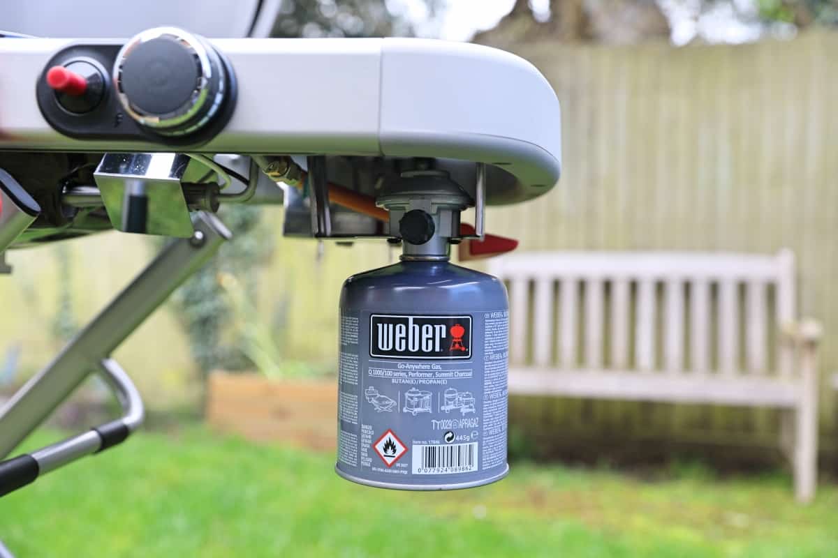 Close up of weber traveler with gas canister connec.