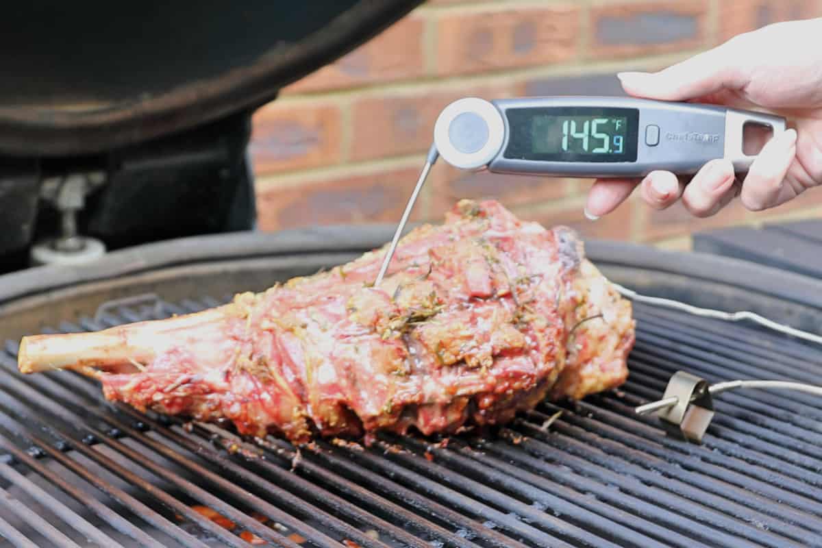 ChefsTemp FinalTouch X10 being used to measure the temperature of a lamb leg on a gr.