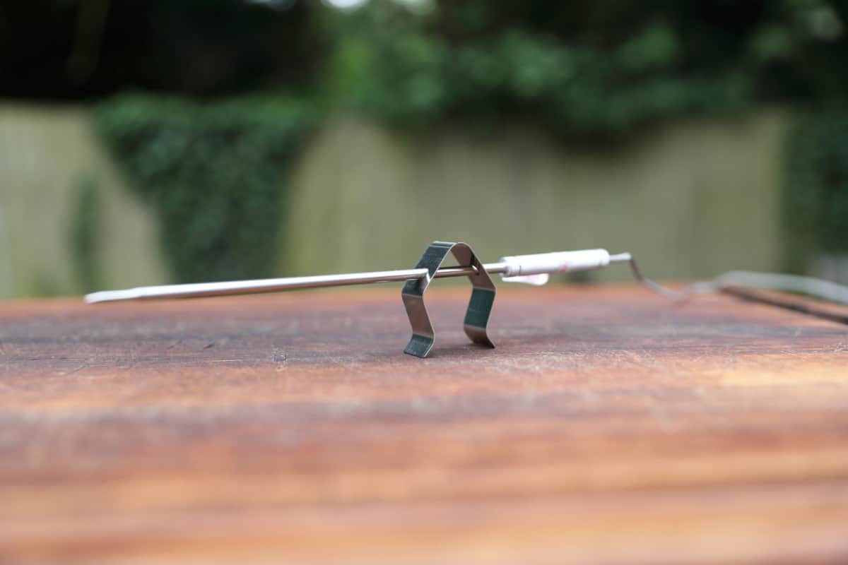 A ThermoPro TP826 probe in the pit clip that can hold it between grill grates to measure the cooking temperature