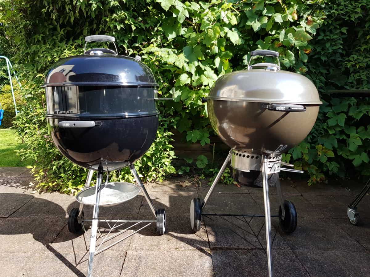 Weber Mastertouch and Original Kettle grills, side by side on a paved pa.