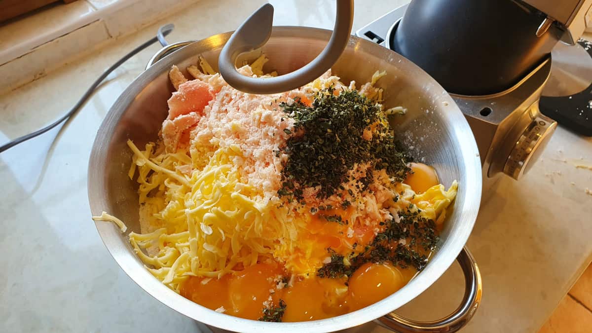 The raw ingredients for pastry inside a stand mixers bowl.