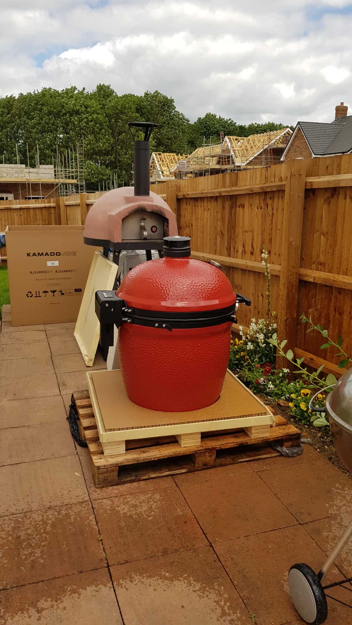 kamado joe big joe 3 larger pallet unboxed to reveal the grill body and lid.