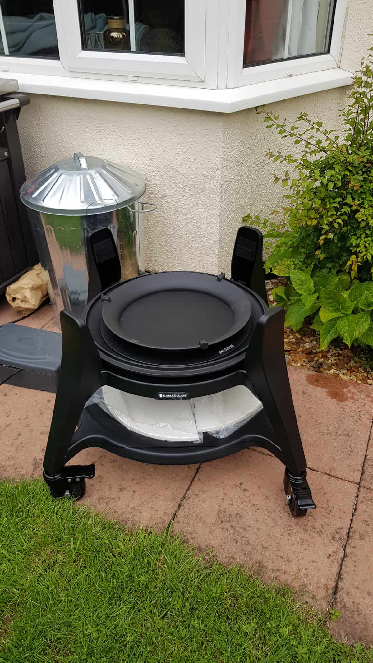 kamado joe big joe 3 cart assembled and sitting on a paved patio.