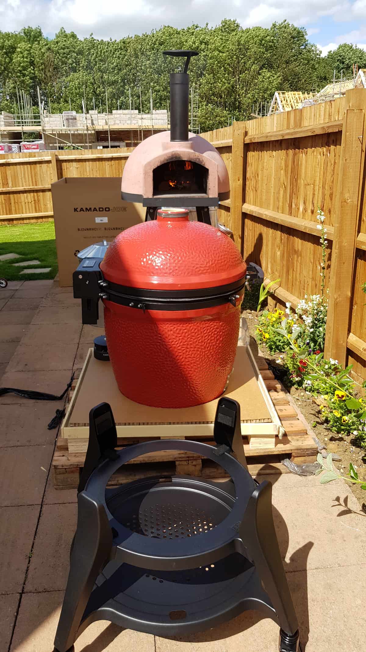 kamado joe big joe 3 unboxed, assembled, but not yet placed in the cart that sits in front of the grill.