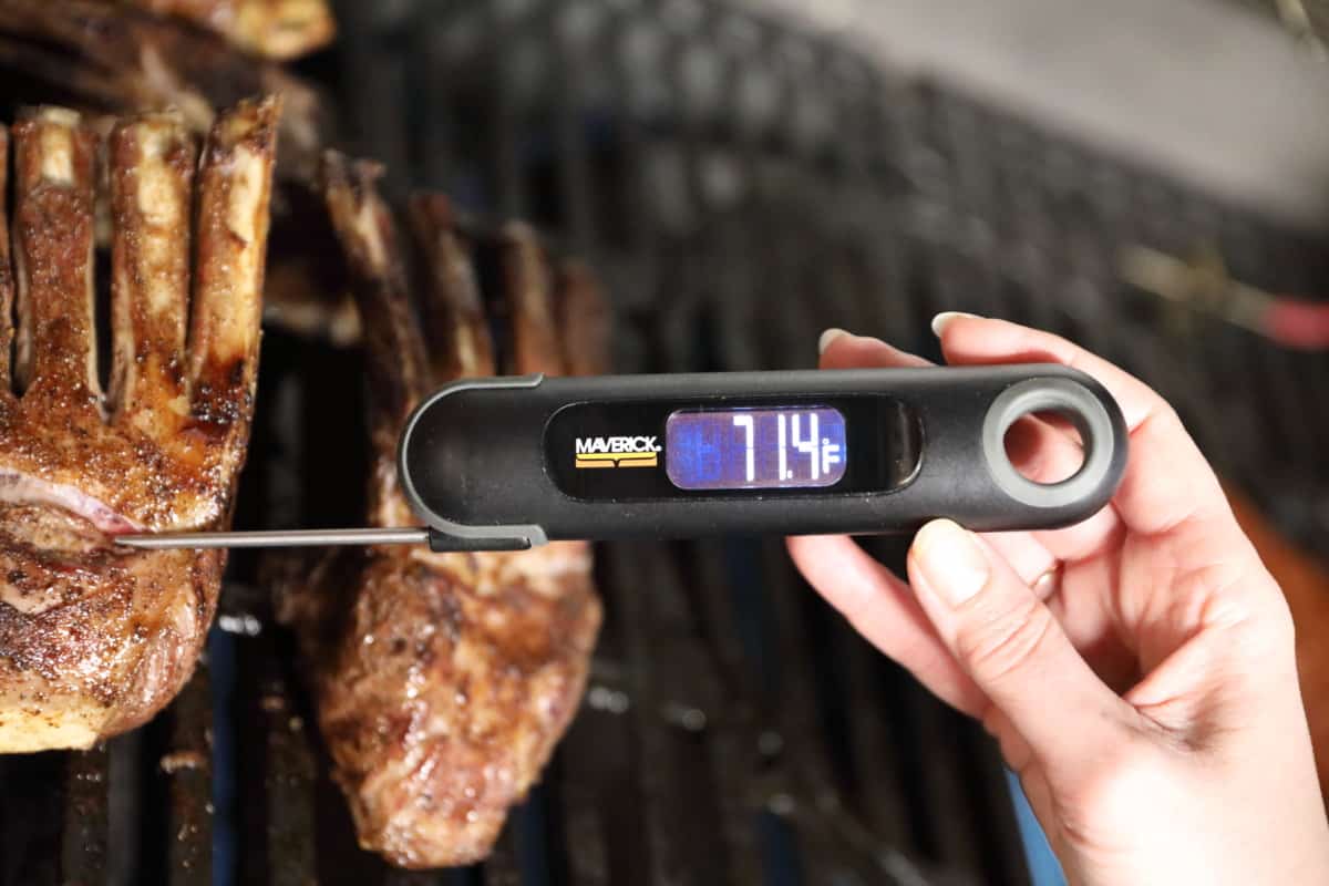 Maverick PT-75 instant-read thermometer being used to take the temp of a rack of lamb on a gr.