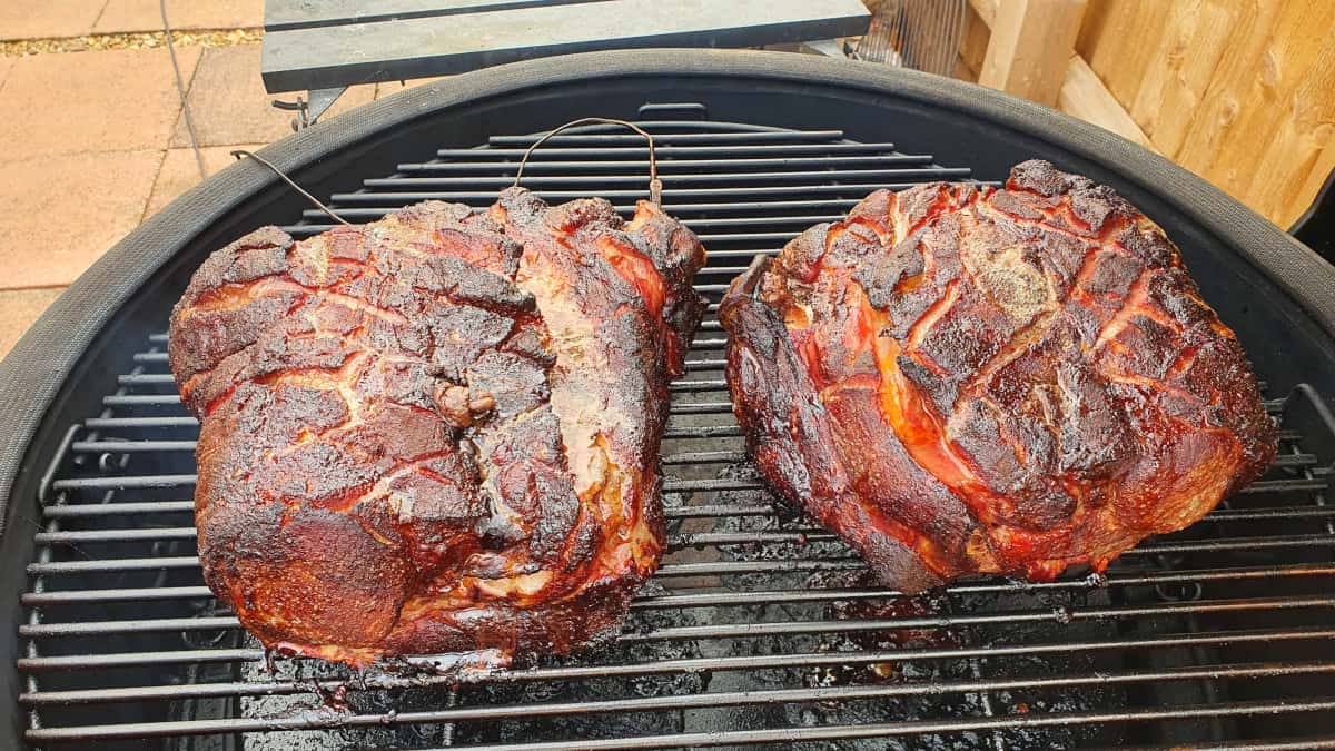 Two pork butts being smoked in a Kamado Joe Big Joe III
