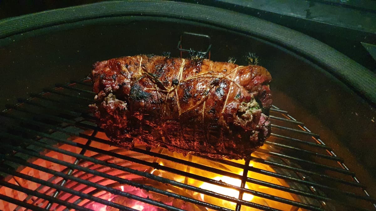 A rolled lamb leg grilling in a KJ Big Joe III.