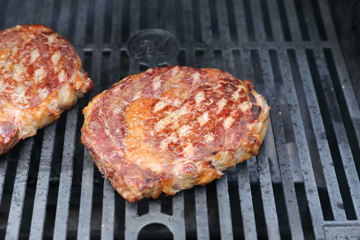 Two steaks searing in the Masterbuilt Gravity series grill and smoker.