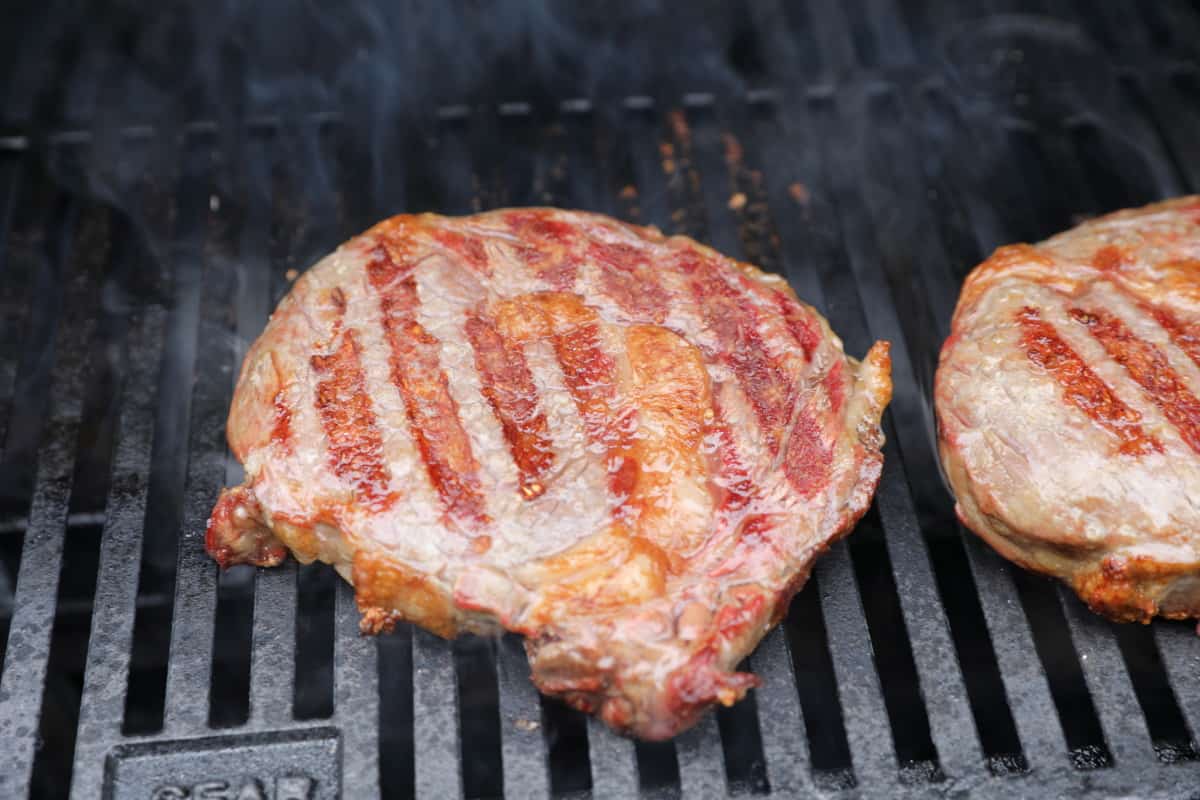 Two steaks searing in the Masterbuilt gravity series smoker.