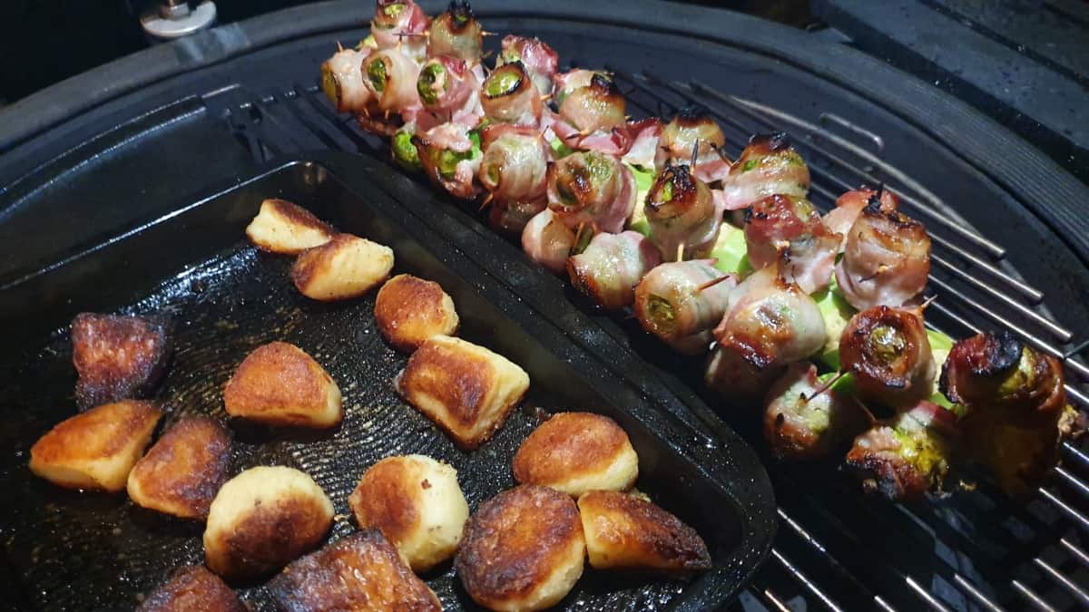 Sprouts and potatoes being roasted inside a Kamado Joe Big Joe III.