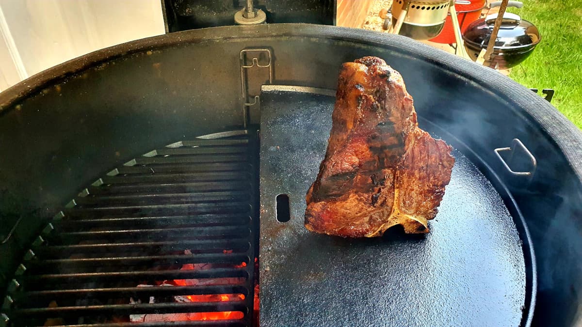T-bone steak slow roasting in a Kamado Joe Big Joe III