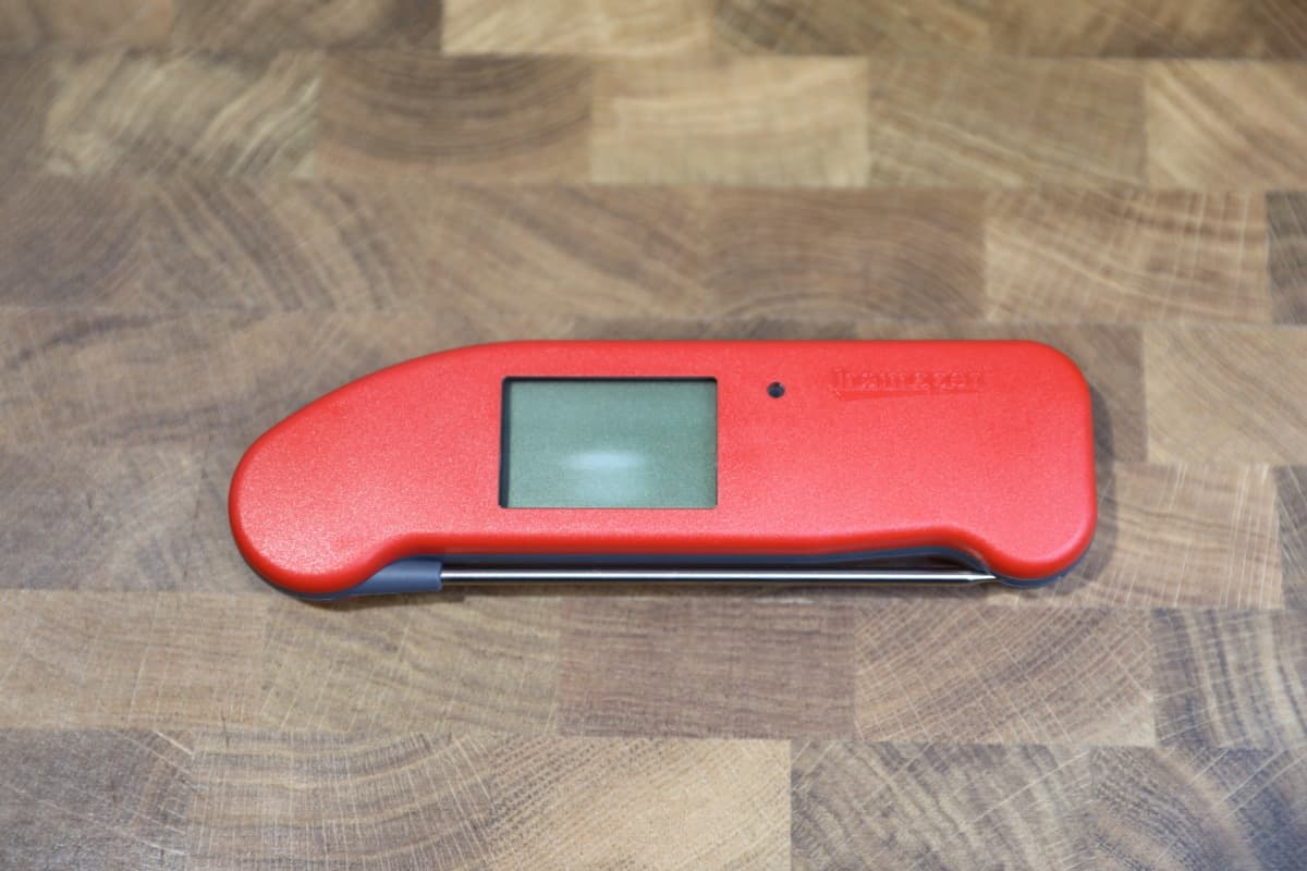 Thermapen One, closed and turned off, sitting on a cutting board