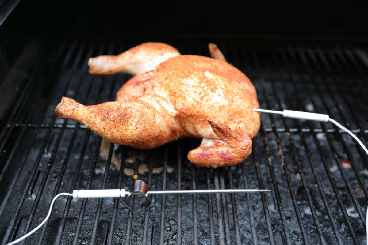 ThermoPro TP826 probes, one in a chicken, the other sitting just above the grill grates using the supplied c.
