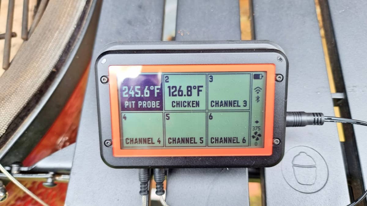 Close up of the FireBoard 2 Drive controller in use, with probes and blower attac.
