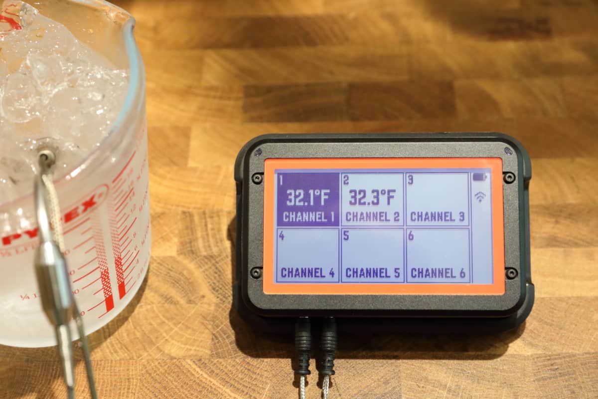FireBoard 2 Drive thermometer with two of its probes in a jug of ice and wa.