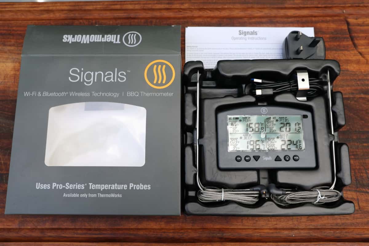 Thermoworks Signals thermometer box opened, sitting on a table.