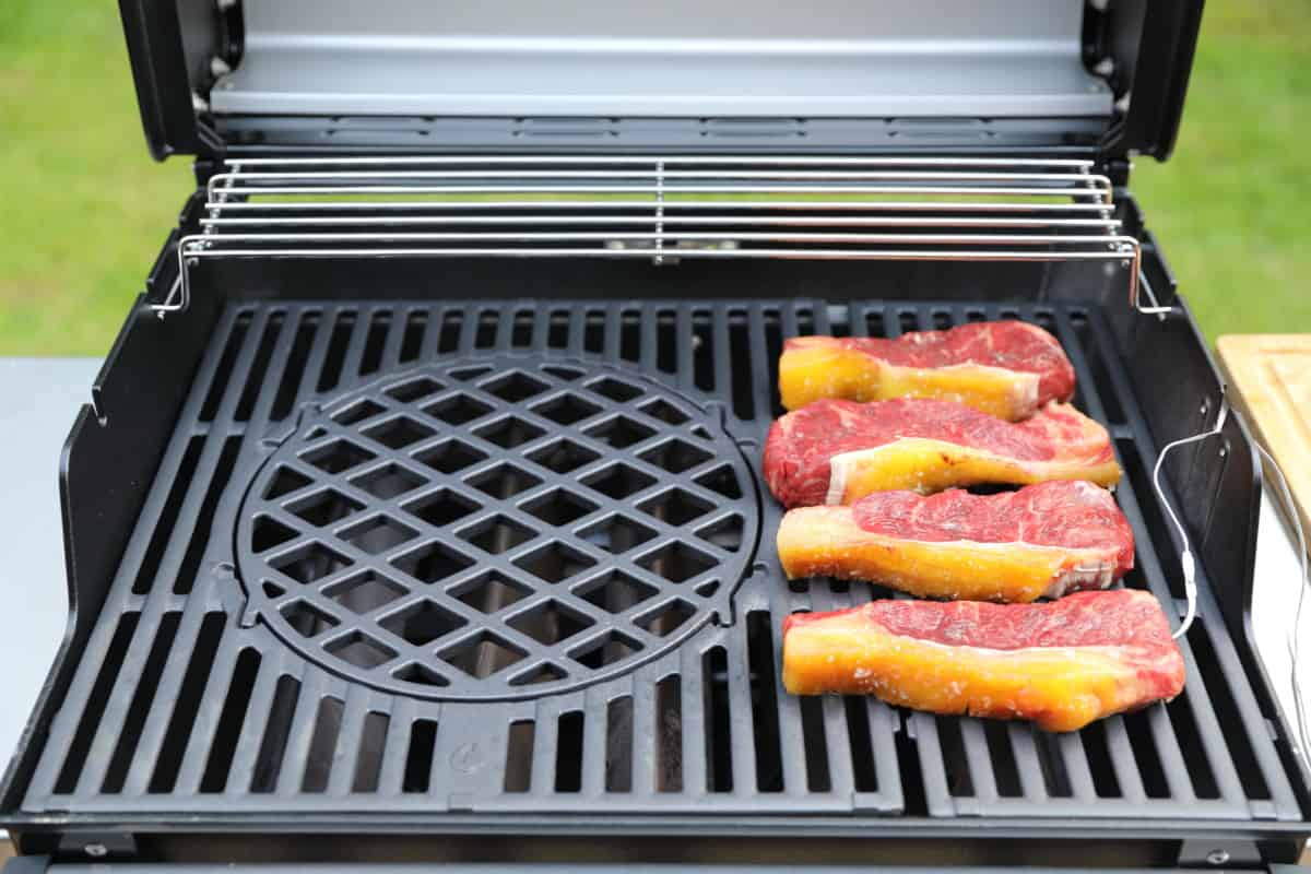 Four sirloin steaks on a weber spirit gas grill