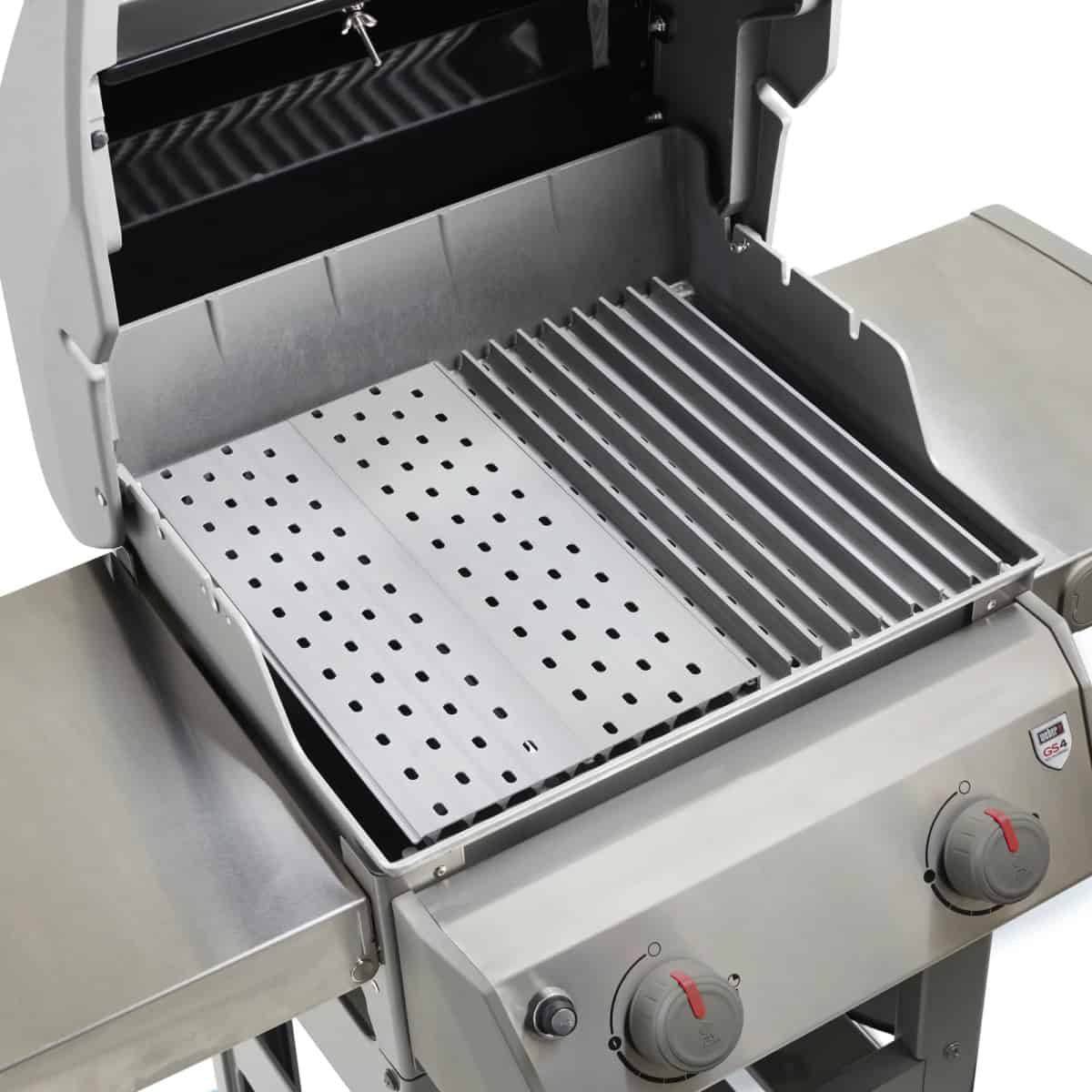 A gas grill with two different sets of grill grates installed.
