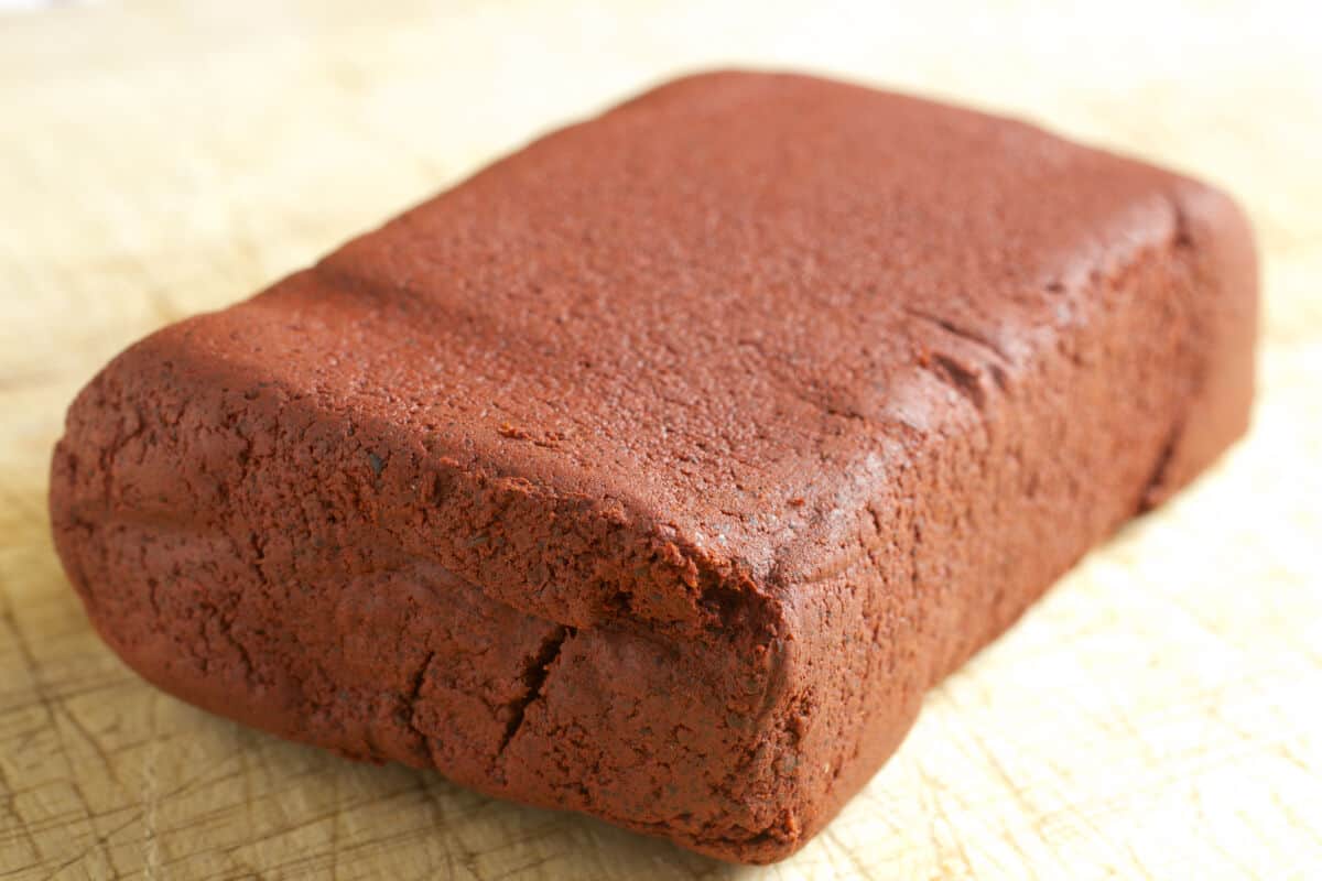 A quite large, brown, and rectangular block of achiote pa.