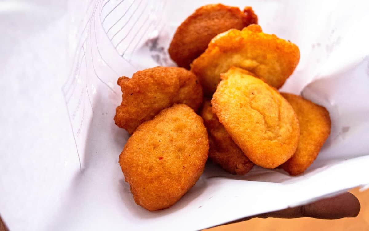 A handful of akara in a white paper w.