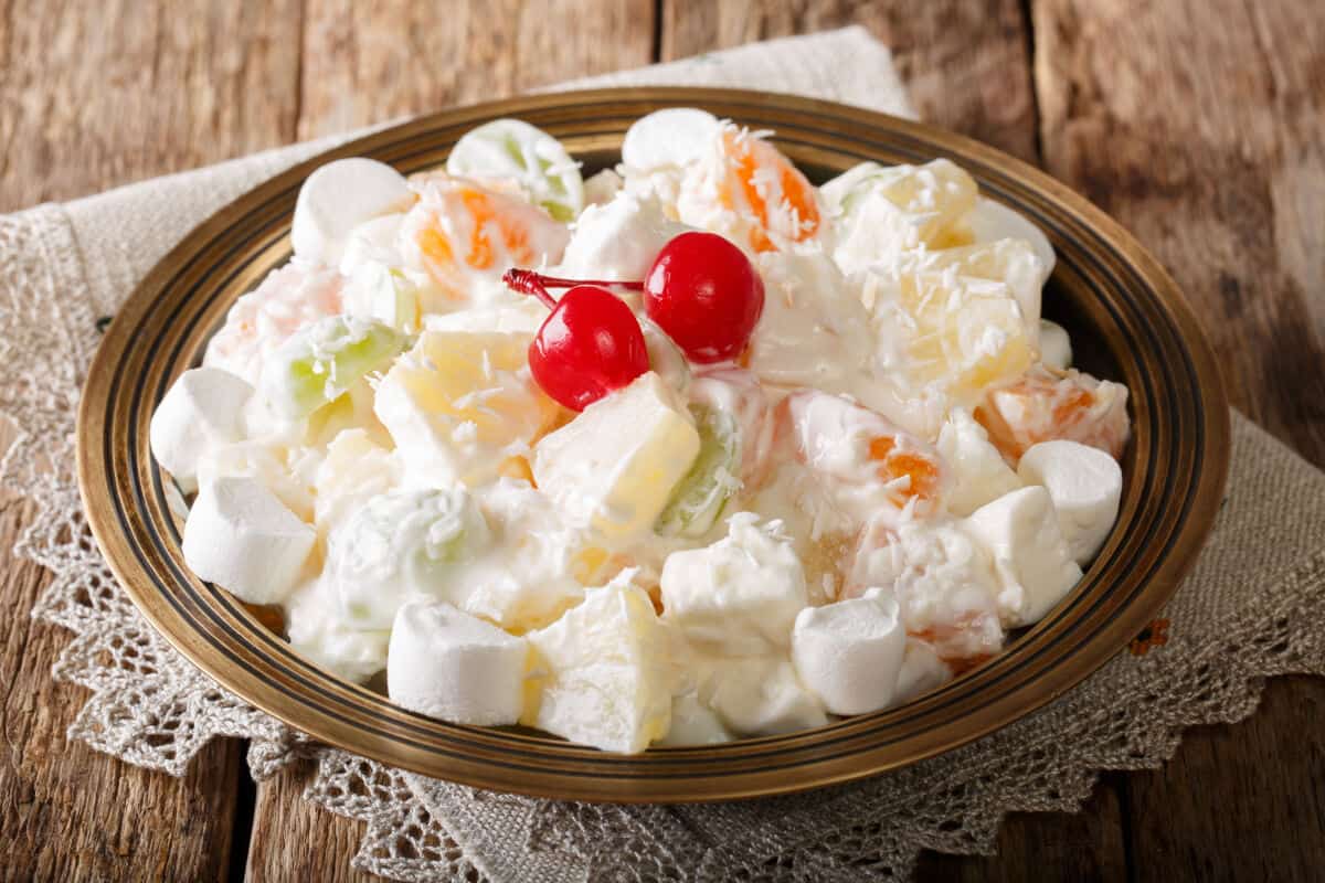 A large bowl of Ambrosia with two cherries on .