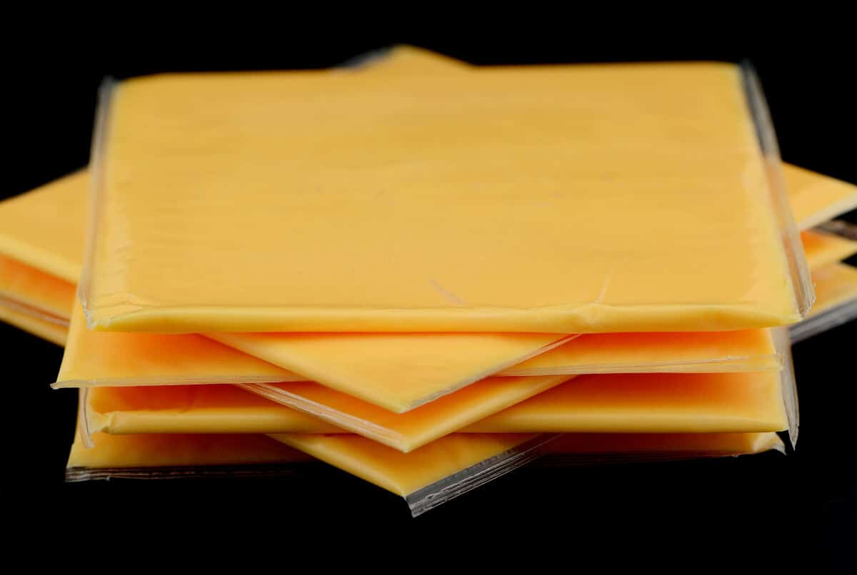 Six slices of American cheese in individual plastic wrapp.