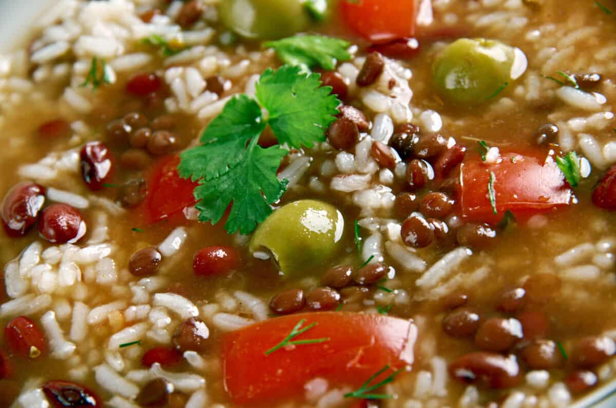 A close up of some asopao, with a coriander leaf on .