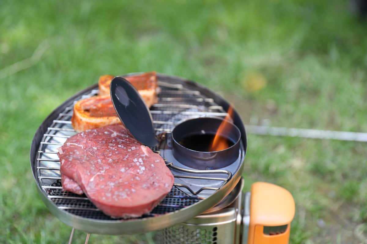 Biolite CampStove with grill attached and chimney open, showing correct flame height to cook on.