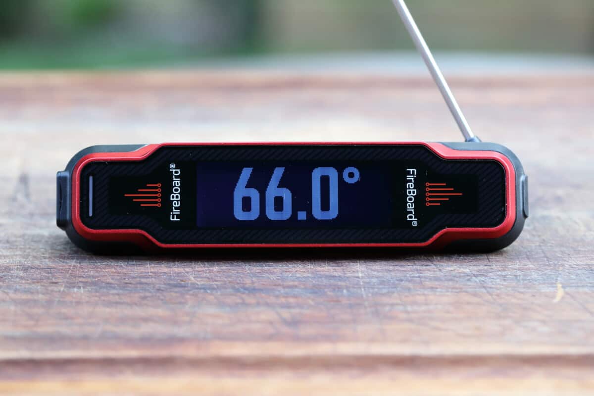 The Fireboard Spark on a cutting board, showing 66 degrees F.