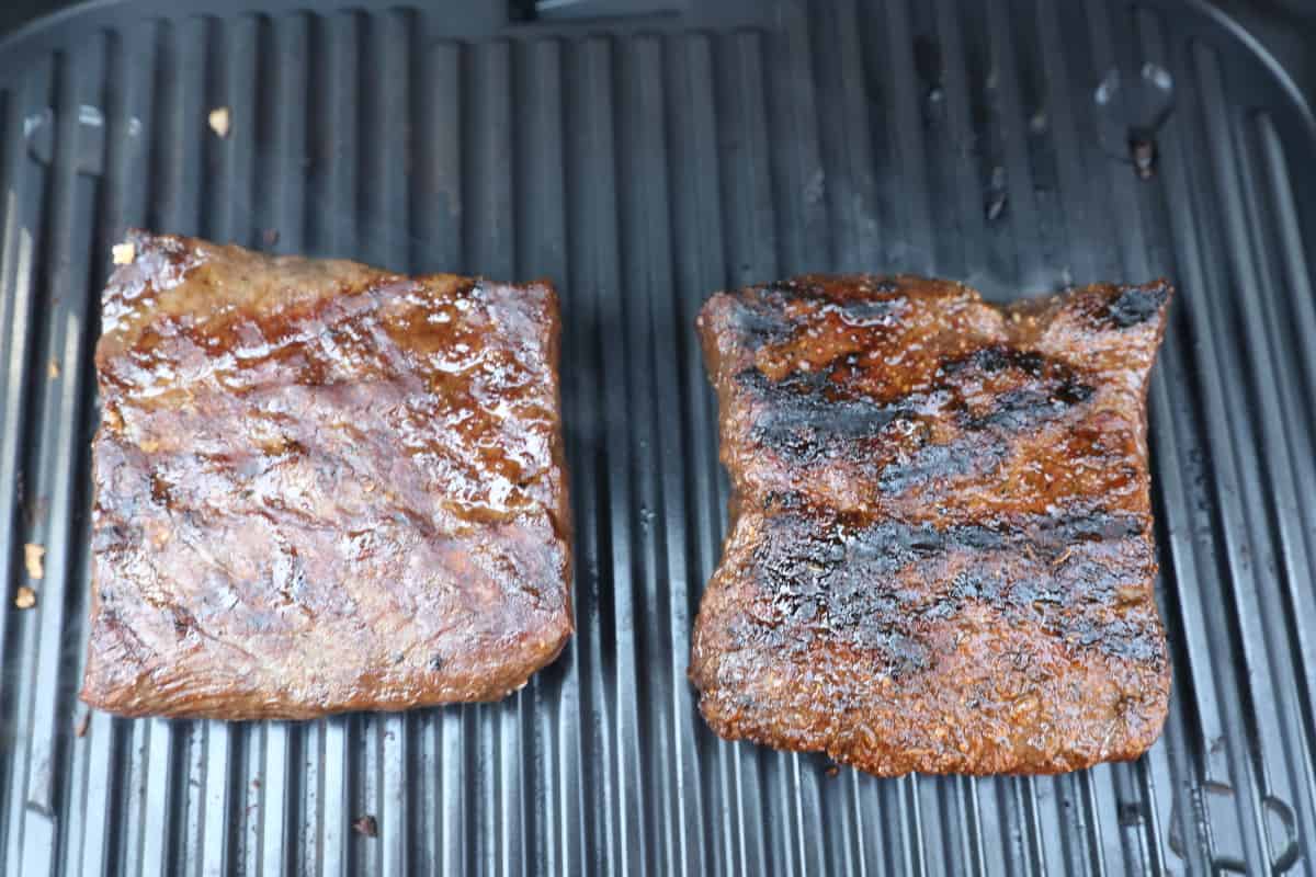 Two perfectly grilled steaks on the Ninja Woodfire grate.