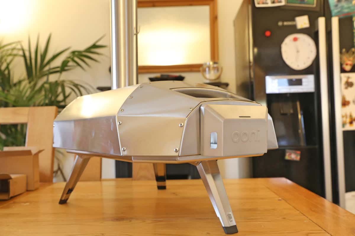 Angled view of the Ooni Karu 12 on a wooden kitchen table.