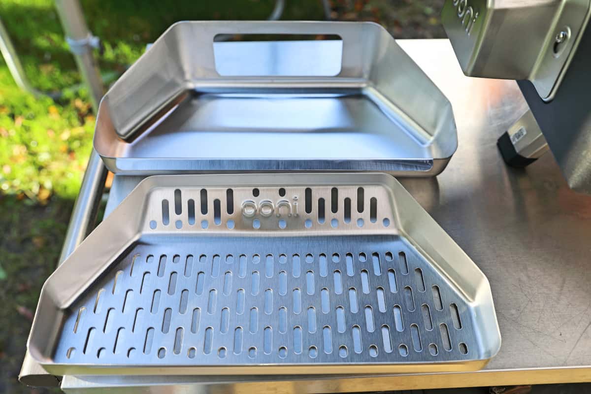 Ooni Karu 16 Fuel Basket and tray on a metal table.