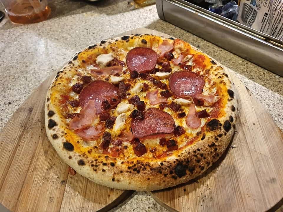 A pizza made on the Ooni Karu 12 pizza oven.