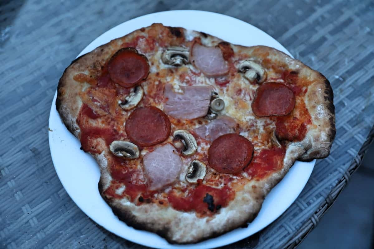An odd-shaped pepperoni pizza that was cooked on an Ooni Karu 16.