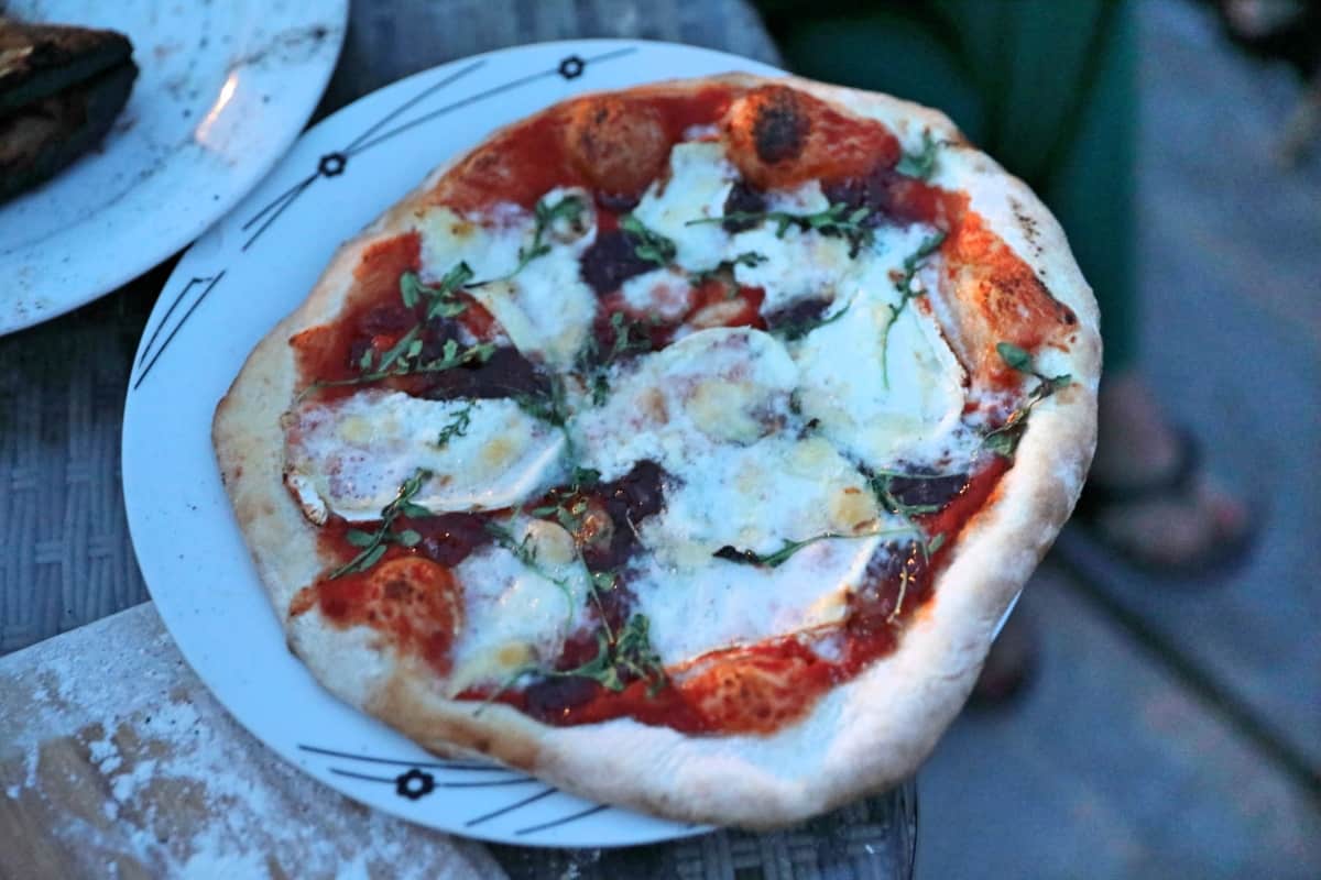 A goat cheese, red onion and rocket pizza that was cooked on an Ooni Karu 16.