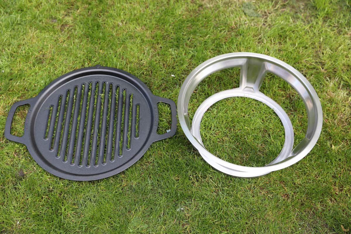 Solo Stove Bonfire hub and grate laid out on grass.